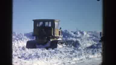 Aspen Colorado (1961): Yellow Snow Plow Pushes Snow Towards Parked Truck On A