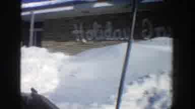 Aspen Colorado (1961): Vehicle Drives Past Building With Holiday Inn Sign On It
