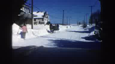 Aspen Colorado (1961): Vehicle Travels Down Snow Covered Residential Street Past A