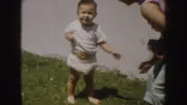 California (1952): Toddler Wearing White Shirt Stands And Walks On Green Grass On