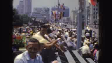 California (1952): A Crowd Of People Sitting On Bleachers Along A Street And Three