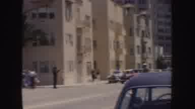 California (1952): Summer Day In A City With Spectators Watching A Parade And A