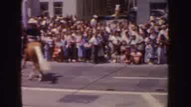 California (1952): Cowboys On Horseback And A White Convertible Parading Past A