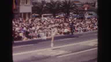 California (1952): A Baton Twirler Leads A Parade In Front Of A Large Audience
