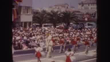 California (1952): Band Members Wearing Red Uniforms March In Parade On A Bright