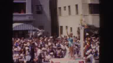 California (1952): Woman On Parade Float Waves To The Crowd As It Drives Down The
