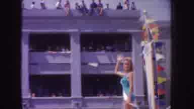 California (1952): Woman On Parade Float Waves The To The Crowd While Wearing A