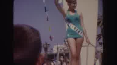 California (1952): Women Wearing Green And Pink Swimwear Wave From White Parade