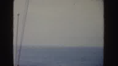 California (1952): View Of Small White Object In Ocean Water On A Cloudy Day