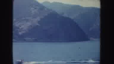 California (1952): Views Of A Shoreline From The Water And A Water Skiing Person