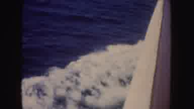 California (1952): View Of Blue Waves Caused By Sailing White Boat On A Clear Day