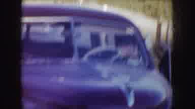 Idaho (1955): Person Wearing Black Coat Talks To Person Sitting In Brown Car