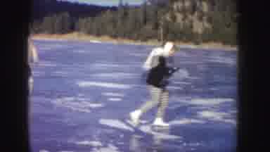 Idaho (1955): Boys Enjoying Skating On A Large Ice Rink Surrounded By Green Trees