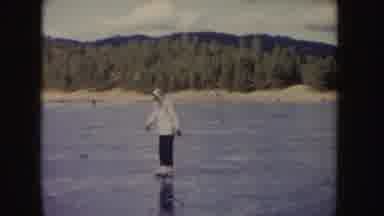 Idaho (1955): Person Wearing White Jacket Skates On Frozen Pond On A Sunny Day