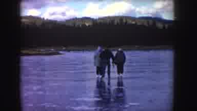 Idaho (1955): Four People Ice Skating On A Frozen Pond During The Day
