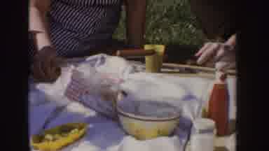 Idaho (1955): Family And Friends Eating Hot Dogs At A Picnic On The Grass Near A