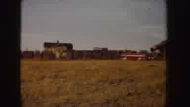 Idaho (1955): Person Rides White Horse Through Tan Field On A Sunny Day