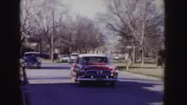 Idaho (1955): Small And Old Cars Walking Around The City In Red And Another Blue