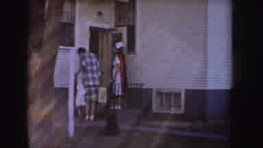 Idaho (1955): Man And Woman Get Out Of Red Car Dressed In White Head To A