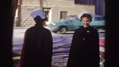 Idaho (1955): Folks Women Man Standing Next To Red Car Dressed Special Occasion In