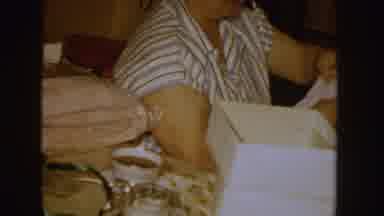 Idaho (1955): Woman Wearing White Shirt Folds Clothes While Woman Wearing Red