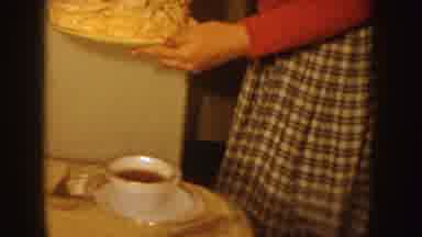 Idaho (1955): Woman Wearing Red Shirt Sets White Cake With Lit Candles On Tan