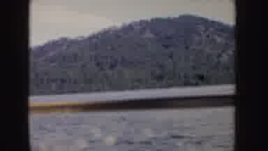 Idaho (1955): Passing View Of Island Full Of Green Trees On A Clear Day