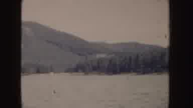 Idaho (1955): View Of Tree Covered Hill And Blue Ocean Water On A Clear Day