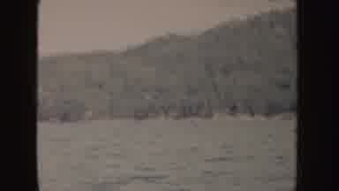 Idaho (1955): Boat With American Flag Waving Driving In Water Near Mountain
