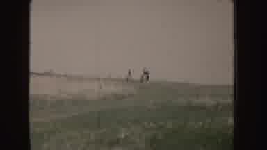 Idaho (1955): Two People Riding Horses At High Speed In The Field