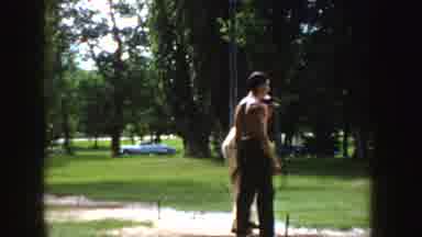 Idaho (1955): Two People In Park Area Pitching Horseshoes On Sunny Day Car Parked