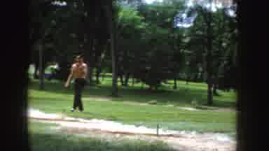 Idaho (1955): Family In Park Kid Makes Face At Camera Mom Laughs Then Man Walking