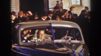 Montana (1939): Crowd Of People Watching A Couple Retreating In Their Beetle