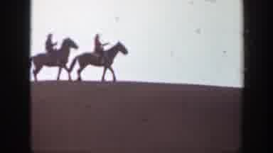 Montana (1939): Two People On Horseback In A Desert