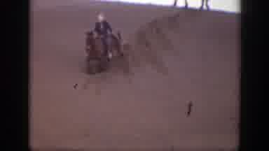 Montana (1939): Person Wearing Blue Jacket Rides Horse Through Sand On A Clear Day