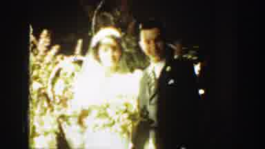 Montana (1939): Man Wearing Black Suit Kisses Woman Wearing White Dress On A