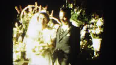 Montana (1939): Woman Wearing White Dress Holds White Flowers While Standing Next