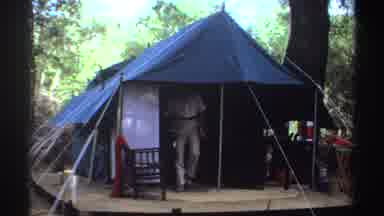 Sudan (1969): Man Walking Out Of Camp Tent Holding Camera Near Forest Area