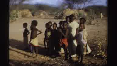 Sudan (1969): African Children In A Group With Mounds Of Grass And Dirt Behind