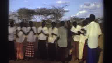 SUDAN-1969: Men Women Culture Dancing African Savanna Clapping Hands Blue Sky