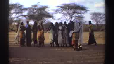 Sudan (1969): Group Of People Standing In Brown Field On A Clear Day