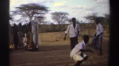 Sudan (1969): Several People Of Color Dancing And A White Man Hunched Over In A