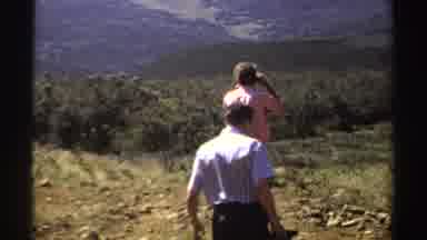 Sudan (1969): Two People Standing On A Large Hill Taking Photos Of The Background