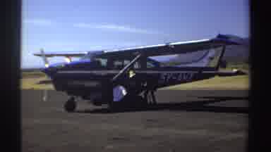 Sudan (1969): Men Messing With Plane Engine Bushes And Mountains In The Background