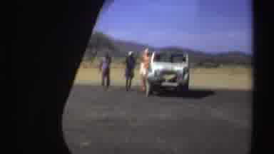 Sudan (1969): Three People Talk Near A Jeep In A Sandy And Mountainous Area Video