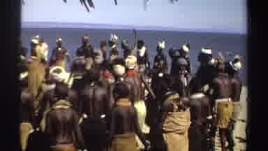 Sudan (1969): Large Group Of People Dancing On The Beach On Bright Sunny Day