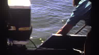 Sudan (1969): An Adult Reaching Into Water Over The Side Of A Boat