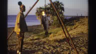 Sudan (1969): Person Wearing Tan Shirt Weighs Grey Fish On A Clear Day