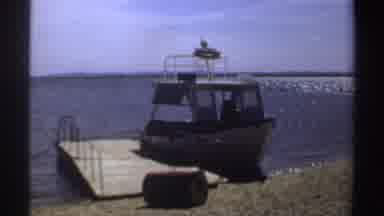 Sudan (1969): A Powerboat Is Tied To A Small Dock Near A Sandy Shore Followed By A