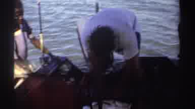 Sudan (1969): A Fisherman Tries To Remove A Hook From A Large Fish Lying On The